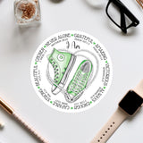 a sticker with a pair of green sneakers on it