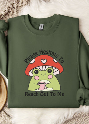a green sweatshirt with a mushroom character and text, along with a mug, a white mug, and some white flowers on a white fur rug.