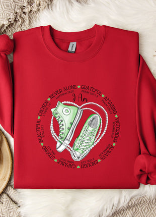 a red shirt with a pair of sneakers on it