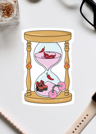 a sticker of an hourglass with a pink liquid inside, surrounded by various objects such as a pair of glasses, a watch, and a pen.