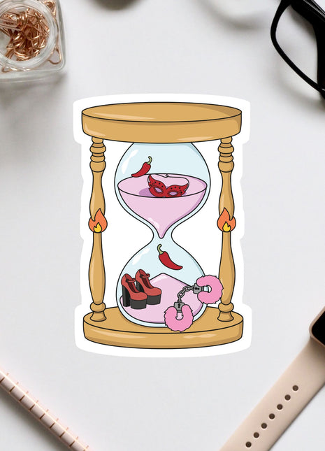 a sticker of an hourglass with a pink liquid inside, surrounded by various objects such as a pair of glasses, a watch, and a pen.