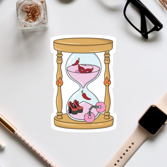 a sticker of an hourglass with a pink liquid inside, surrounded by various objects such as a pair of glasses, a watch, and a pen.