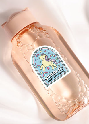 a close up of a bottle on a white surface