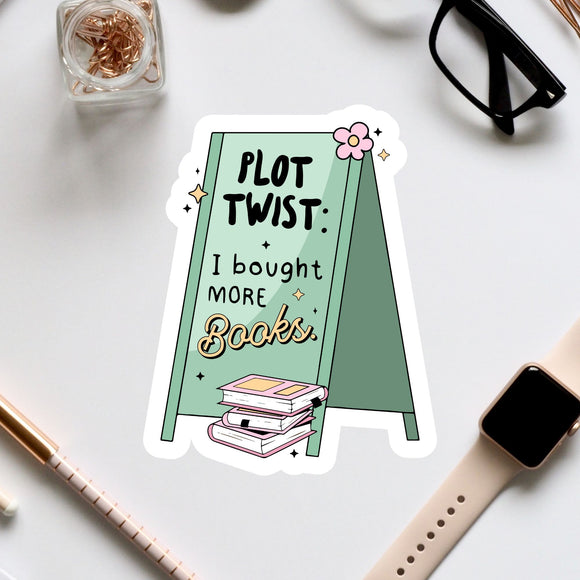 a table topped with a pile of books next to a pair of glasses