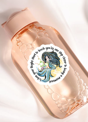 a bottle with a sticker of a mermaid on it