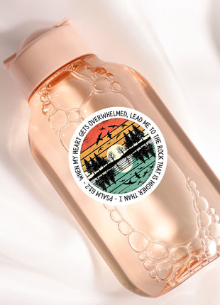 A pink bottle with a label featuring a colorful graphic and text.