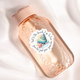 A pink bottle with a sticker featuring a seashell and starfish, along with the text "And to the beach I go to lose my mind and love the beach".