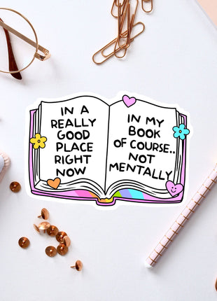 an open book with words on it next to a notebook