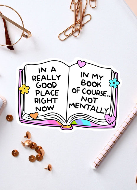 an open book with words on it next to a notebook
