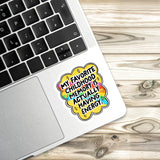 A sticker with a colorful design and text is placed on the edge of a laptop keyboard.