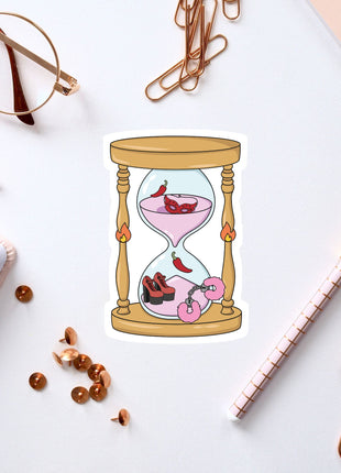 a stylized illustration of a glass hourglass with a pink liquid inside, surrounded by various office supplies such as pens, a notebook, and a pair of glasses.