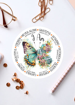 a clock with a butterfly on it next to a notepad