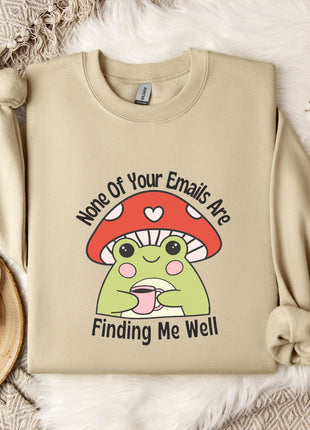 a beige sweatshirt with a mushroom graphic and text, along with a mug, a snowflake, and some cotton balls, all placed on a white fur rug.