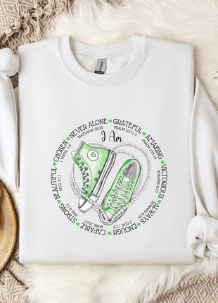 a white sweatshirt with a green sneaker on it