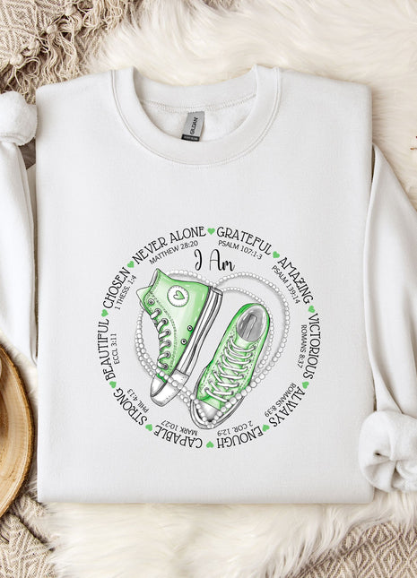 a white sweatshirt with a green sneaker on it