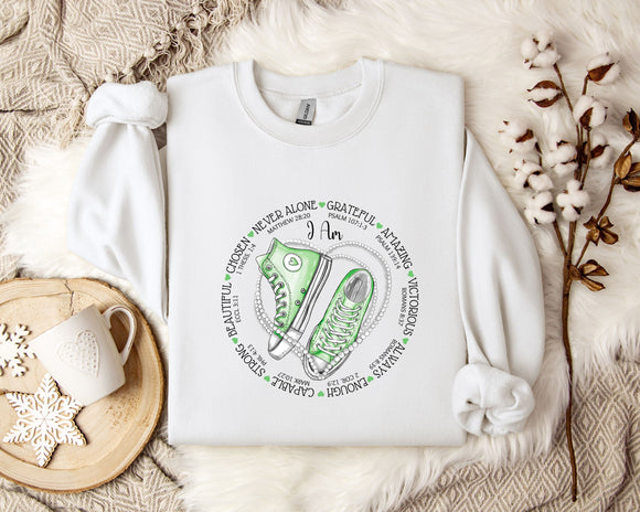 a white sweatshirt with a green sneaker on it