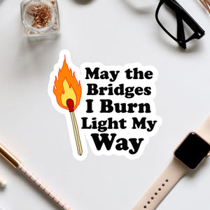 a sticker that says, may the bridges i burn light my way