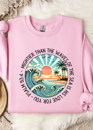 a pink sweater with a picture of a sunset on it