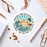 a sticker with a picture of a sunset and a wave