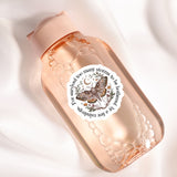 A pink bottle with a label featuring a butterfly and the text "I survive too many storms to be a butterfly"
