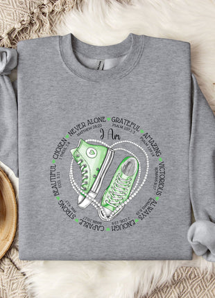 a sweater with a pair of sneakers on it