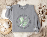 a sweater with a pair of sneakers on it