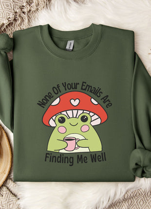 a green sweatshirt with a mushroom graphic and text, along with a mug and a snowflake on a white surface.