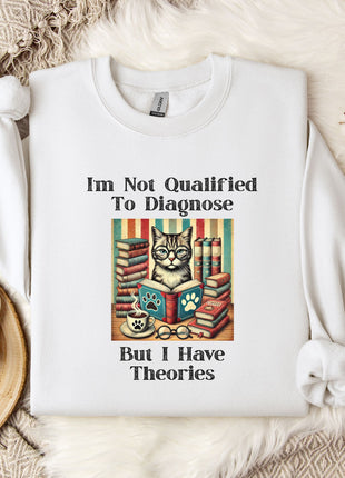 a white t-shirt with a humorous text and an illustration of a cat surrounded by books, placed on a bed with a white blanket and a mug.