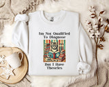 a white t-shirt with a humorous text and an illustration of a cat surrounded by books, placed on a bed with a white blanket and a mug.