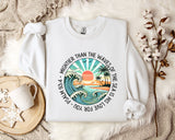 a white sweatshirt with a picture of a sunset on it