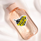 a bottle with a sticker on it sitting on a white surface