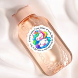 a pink bottle with a unicorn sticker on it