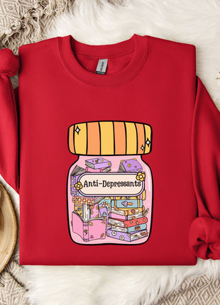 A red sweater with a graphic design of a jar containing various objects, including books and a teapot, is displayed on a white fur-covered surface.