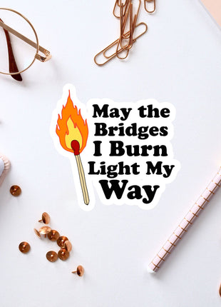 a sticker that says, may the bridges i burn light my way