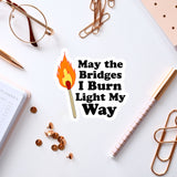 a sticker that says, may the bridges i burn light my way