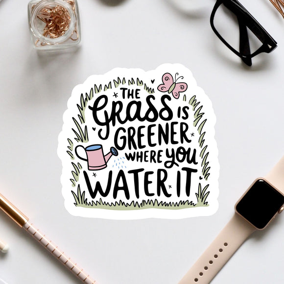 a sticker with a hand-drawn illustration of a watering can and a butterfly, surrounded by text that reads 
