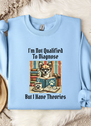 A light blue sweatshirt with a printed design of a dog wearing glasses and surrounded by books, along with the text "I'm Not Qualified To Diagnose But I Have Theories".
