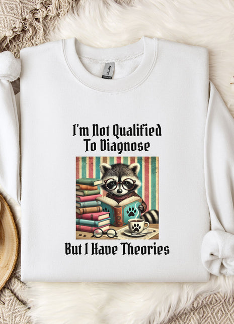 a white t-shirt with a graphic design of a raccoon reading a book, accompanied by the text "I'm Not Qualified To Diagnose" and "But I Have Theories".