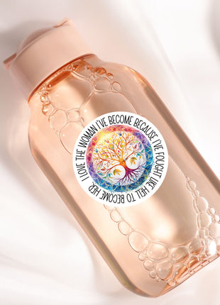 A pink bottle with a label featuring a tree design and text.