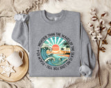 a sweater with a picture of a sunset on it