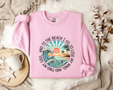 A pink sweatshirt with a graphic design depicting a beach scene, along with the text "And to the beach I go, I lose my soul, I lose my mind".