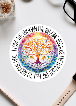 a colorful, intricate tree design with a quote around it, surrounded by various office supplies such as a pair of glasses, a watch, and a pen.