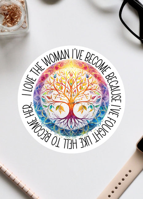 a colorful, intricate tree design with a quote around it, surrounded by various office supplies such as a pair of glasses, a watch, and a pen.