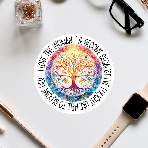 a colorful, intricate tree design with a quote around it, surrounded by various office supplies such as a pair of glasses, a watch, and a pen.