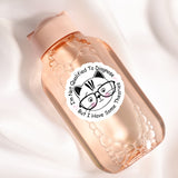 A pink bottle with a sticker featuring a cat's face and the text "I'm Not Qualified To Diagnose"