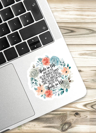 a sticker with a floral design placed on the edge of a laptop keyboard.