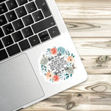 a sticker with a floral design placed on the edge of a laptop keyboard.