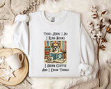 A white t-shirt with a printed design of a cat and books, along with text that says "Thats what I do I read books I drink coffee and I know things".