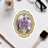 a Halloween-themed sticker or illustration of a castle, surrounded by various Halloween-related items such as a ghost, a spider, and a skeleton.