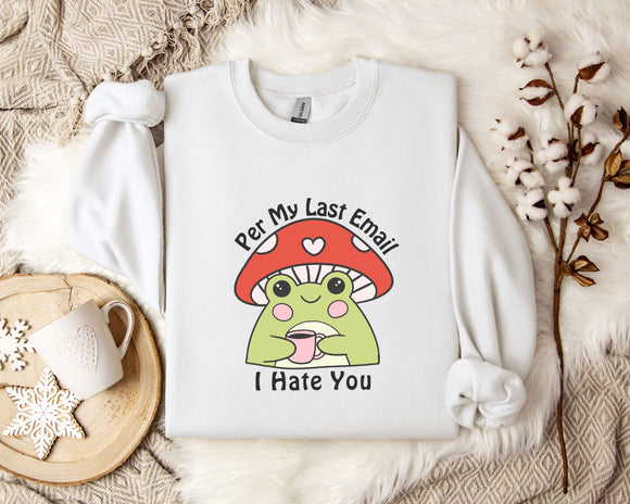 a white sweatshirt with a cartoon frog wearing a red mushroom hat and holding a cup, accompanied by the text 